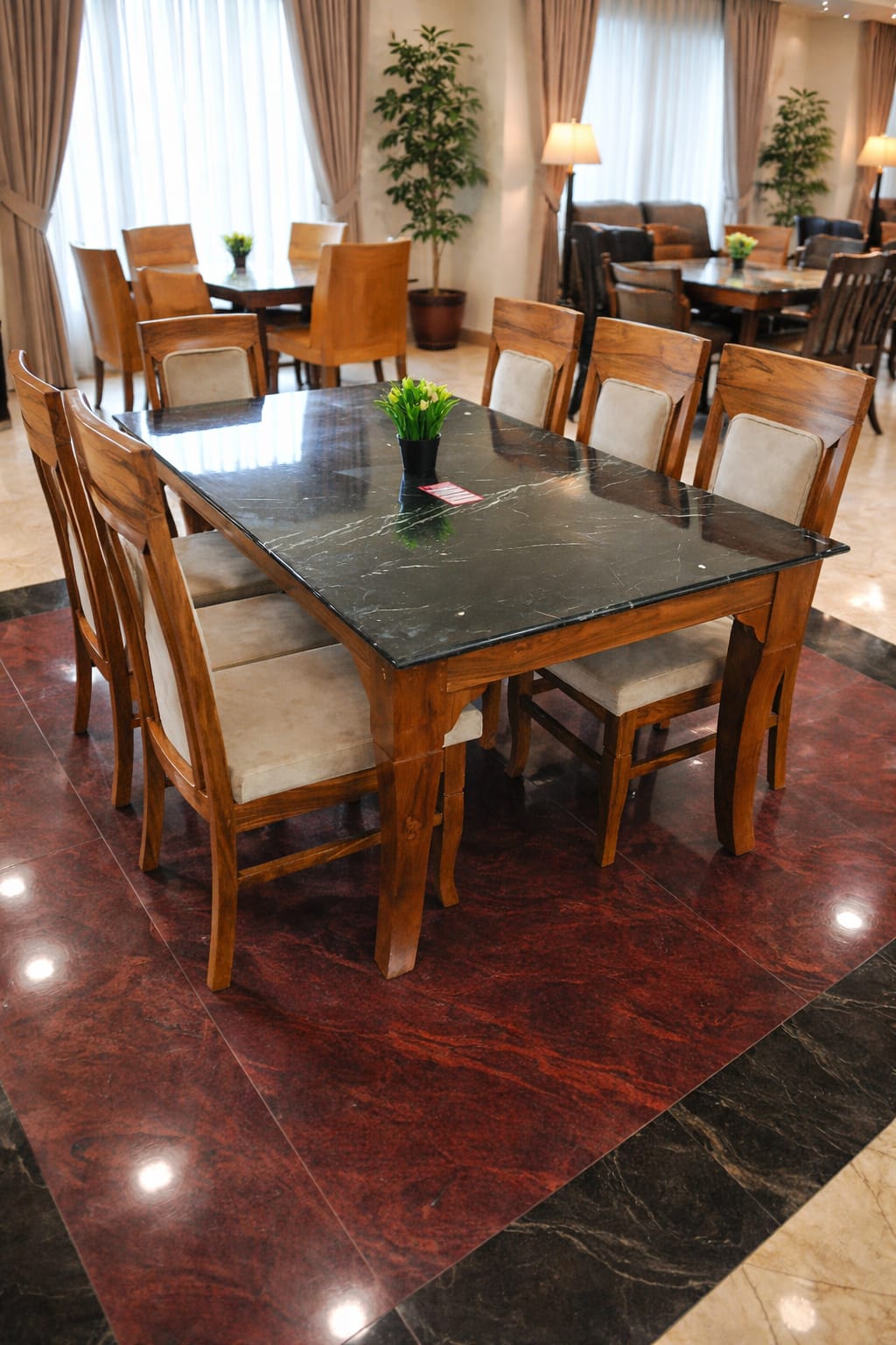 black marble top and a medium brown wooden frame.